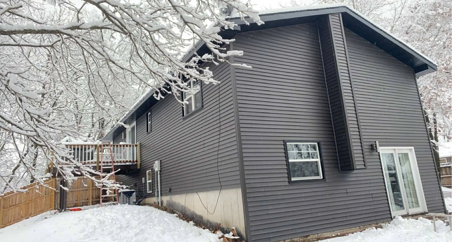 Side view of two-story house with charcoal lap siding, Chippewa Valley WI