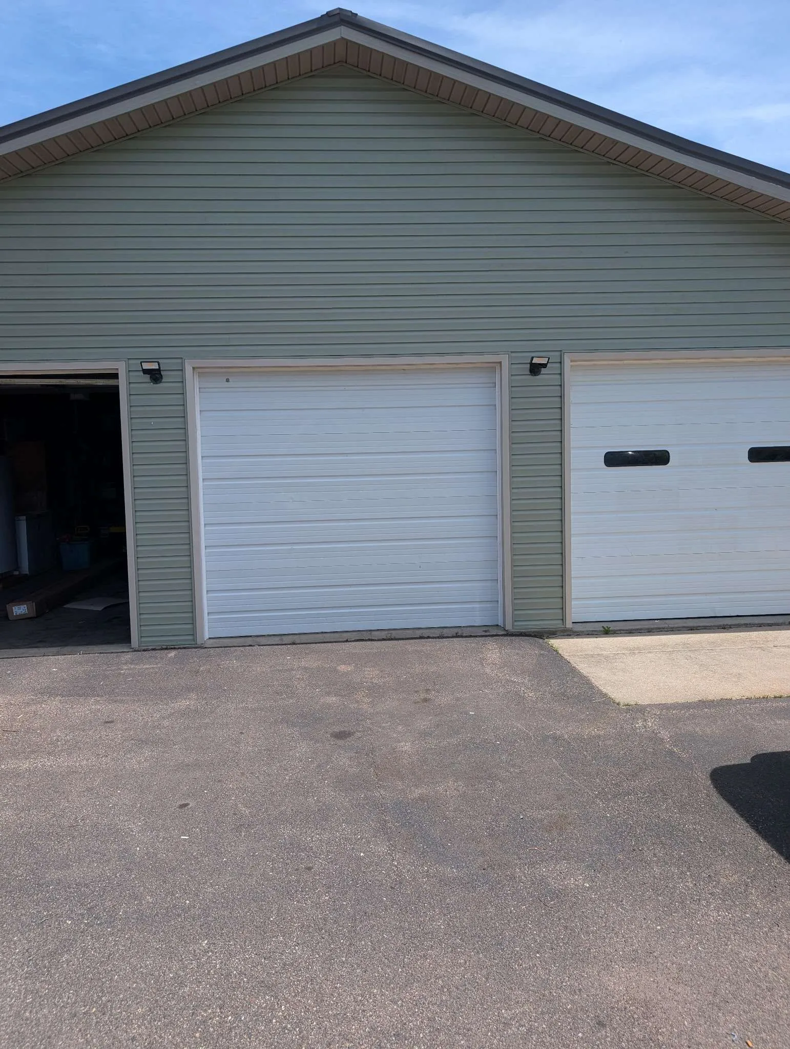 Completed triple garage with sage green horizontal lap siding, Chippewa Valley WI
